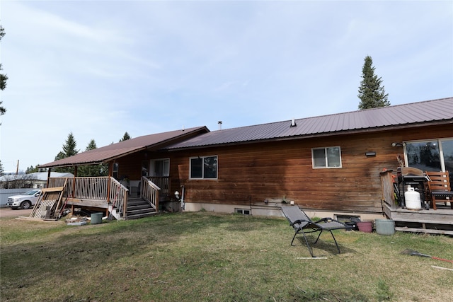 261 Locust Ln, Seeley Lake, MT 59868 - back of house with metal roof, a lawn, and a wooden deck
