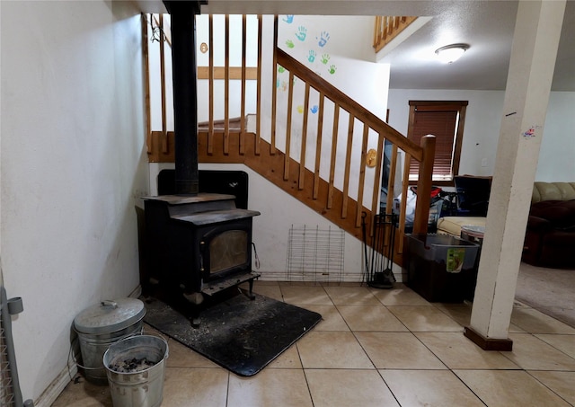 261 Locust Ln, Seeley Lake, MT 59868 - staircase featuring a wood stove and tile patterned floors