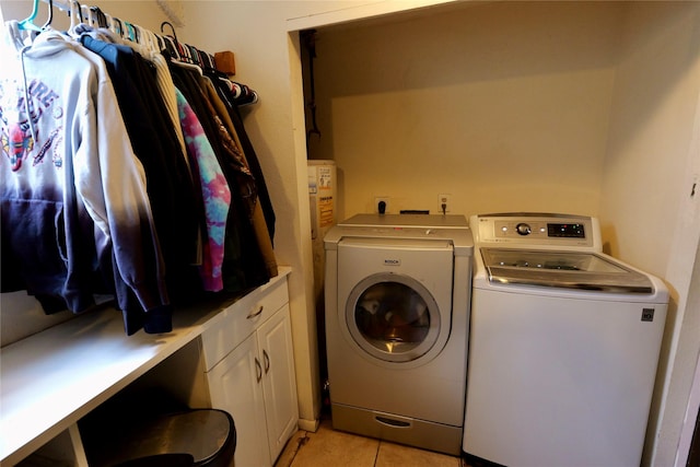 261 Locust Ln, Seeley Lake, MT 59868 - laundry area with washer and clothes dryer, cabinet space, and light tile patterned floors