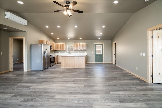 471 Lower Deep Creek Rd, Townsend, MT 59644 - kitchen with a wall mounted AC, lofted ceiling, light brown cabinetry, and stainless steel appliances