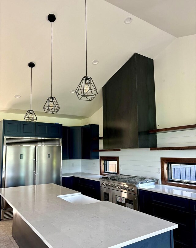 192 Glacier Flats Rd, Kalispell, MT 59901 - kitchen featuring high quality appliances, a center island, light stone countertops, hanging light fixtures, and lofted ceiling