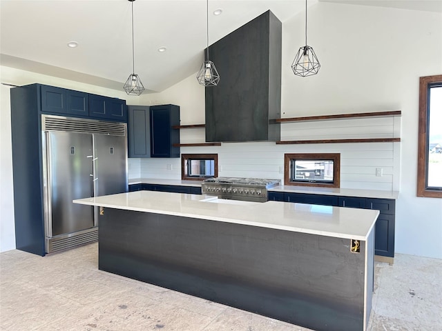 192 Glacier Flats Rd, Kalispell, MT 59901 - kitchen featuring premium appliances, blue cabinets, vaulted ceiling, light countertops, and tasteful backsplash
