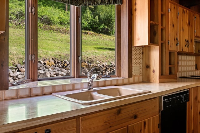 2041 Sleeping Child Rd, Hamilton, MT 59840 - kitchen featuring dishwasher, light countertops, and brown cabinets