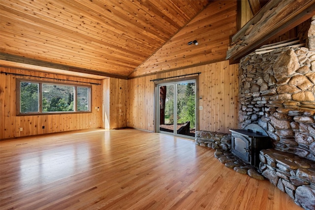 2041 Sleeping Child Rd, Hamilton, MT 59840 - unfurnished living room featuring high vaulted ceiling, a wood stove, wood finished floors, wood ceiling, and wood walls