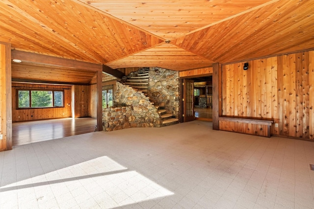 2041 Sleeping Child Rd, Hamilton, MT 59840 - unfurnished living room with wood ceiling, wood walls, vaulted ceiling, and stairs