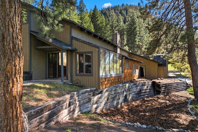 2041 Sleeping Child Rd, Hamilton, MT 59840 - view of property exterior with a chimney and a view of trees