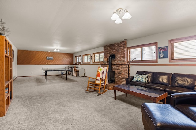 carpeted living room featuring visible vents and a wood stove