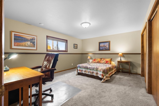 bedroom with carpet flooring, a closet, and baseboards
