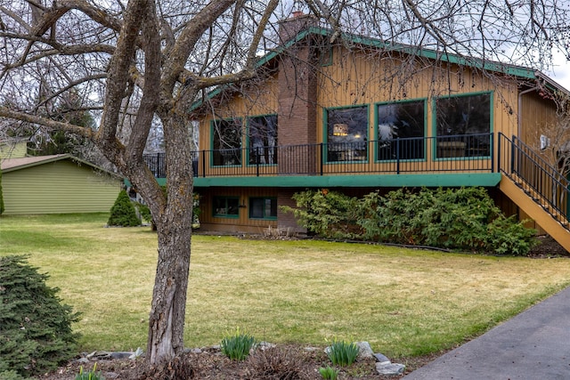 rear view of house with a yard