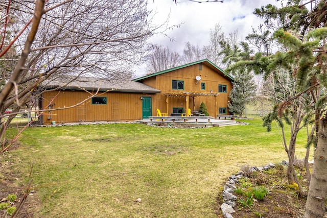 rear view of house featuring a patio area and a lawn