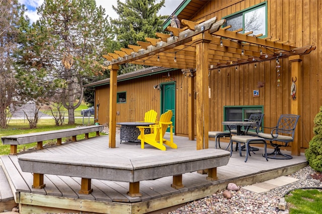deck with a pergola and outdoor dining space