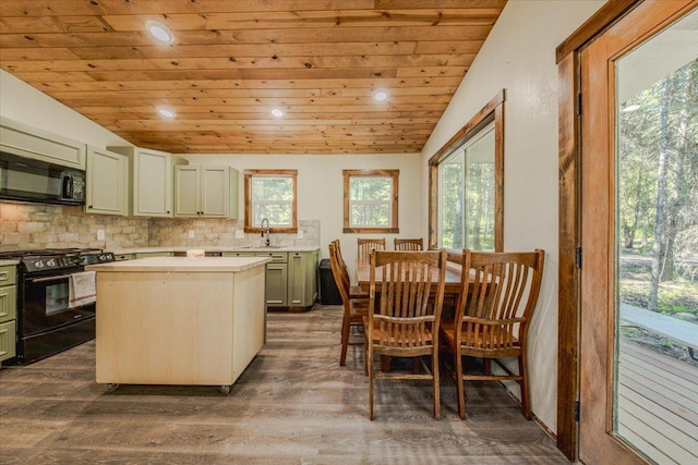 1365 Bierney Creek Rd, Lakeside, MT 59922 - kitchen featuring black appliances, wood ceiling, light countertops, backsplash, and dark wood-style flooring