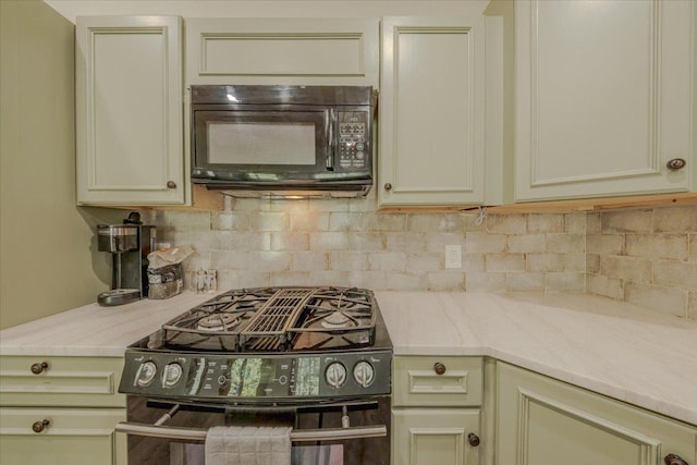 1365 Bierney Creek Rd, Lakeside, MT 59922 - kitchen featuring black appliances, light countertops, backsplash, and cream cabinetry