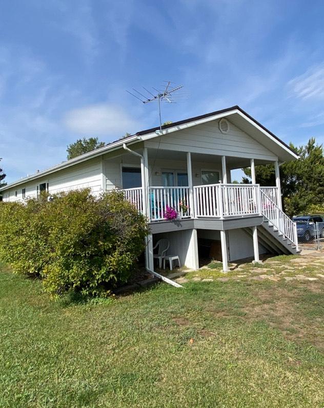 view of front facade with a front yard and stairway