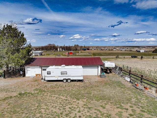view of yard with an outbuilding, a garage, and fence