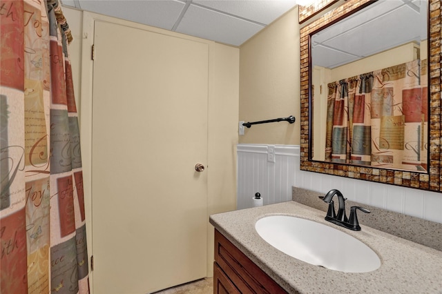 full bathroom with vanity and wainscoting