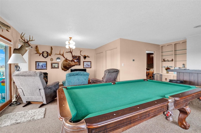 game room featuring pool table, a notable chandelier, built in features, a textured ceiling, and carpet floors