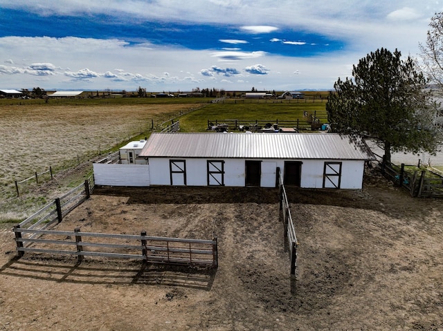exterior space featuring an exterior structure and a rural view