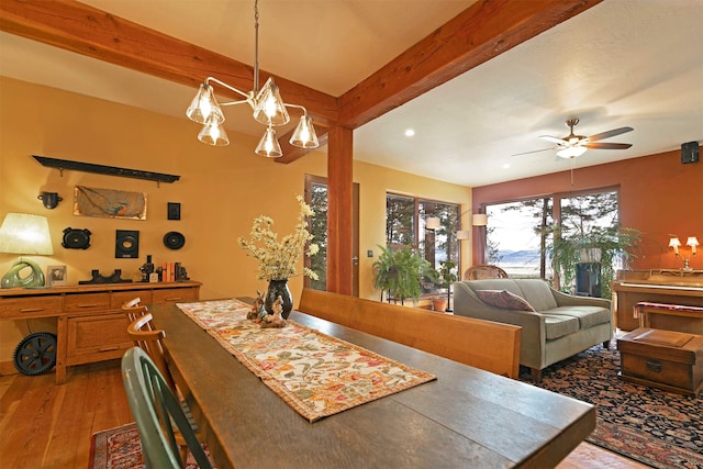 dining area with beamed ceiling, recessed lighting, wood finished floors, and ceiling fan with notable chandelier