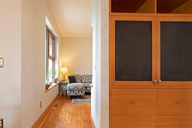 hall with visible vents and light wood finished floors
