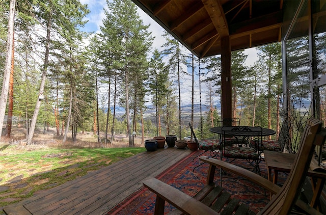 wooden terrace featuring outdoor dining area
