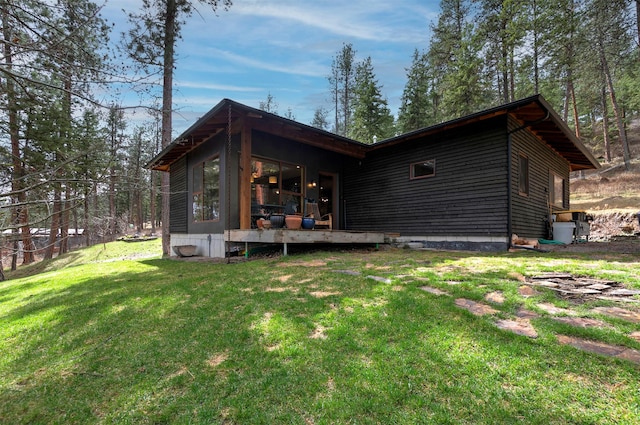 rear view of property featuring a yard