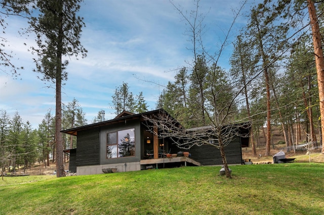 back of property with a lawn