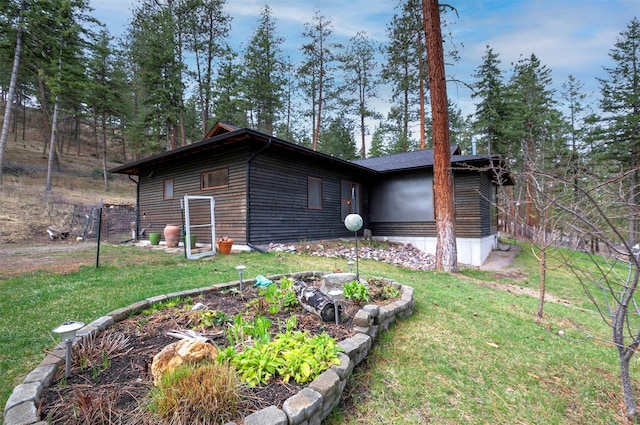 view of side of property with a yard