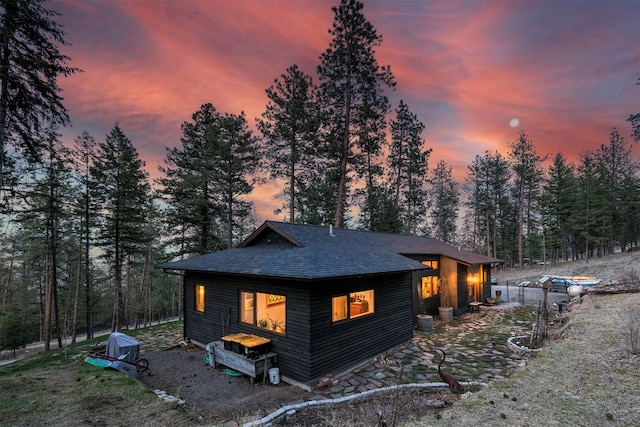 exterior space with roof with shingles