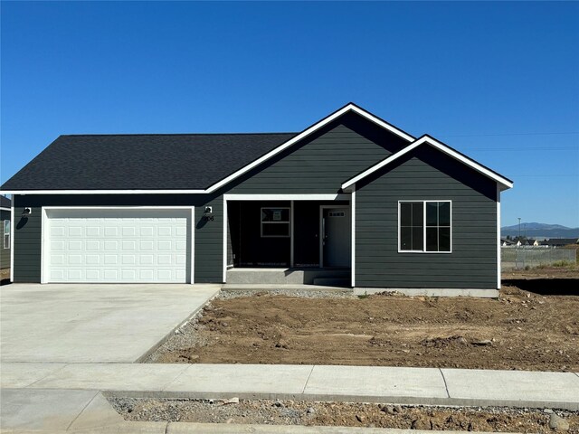 327 Meadow View Loop, East Helena, MT 59635 - ranch-style house with a porch, a mountain view, an attached garage, and concrete driveway