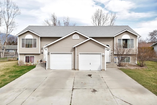 bi-level home featuring a front yard, driveway, and roof with shingles