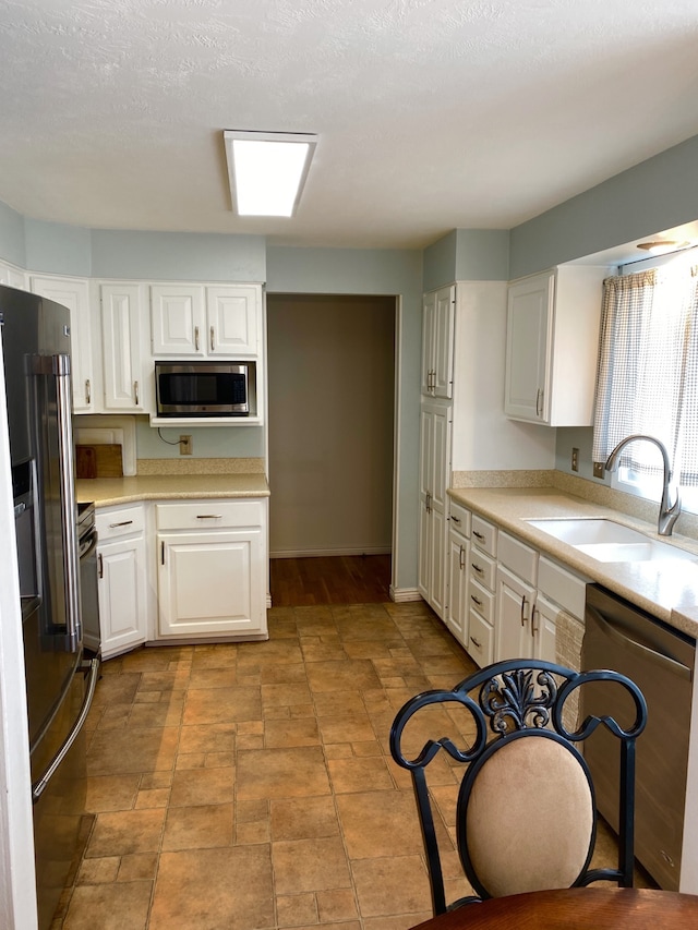 1405 2ND W Hill Dr, Great Falls, MT 59404 - kitchen with dishwasher, stainless steel microwave, high quality fridge, light countertops, and white cabinetry