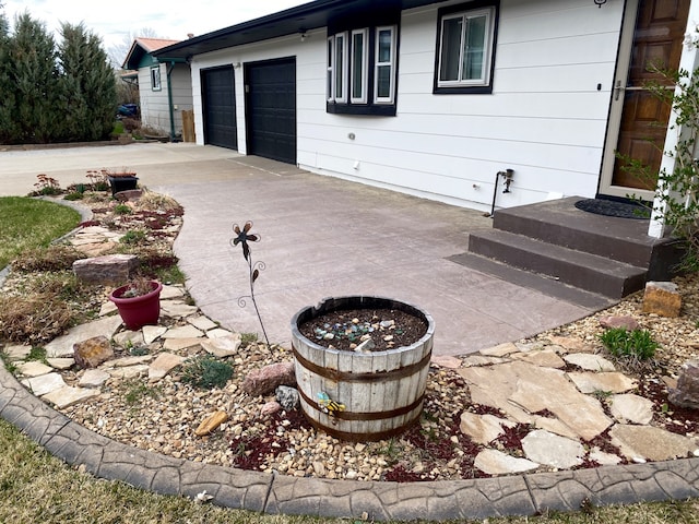 1405 2ND W Hill Dr, Great Falls, MT 59404 - view of patio / terrace featuring a garage and driveway