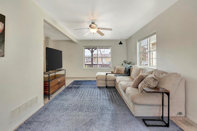 living area with visible vents and a ceiling fan