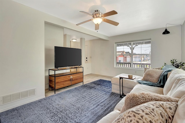 living room featuring visible vents, baseboards, a ceiling fan, and carpet floors