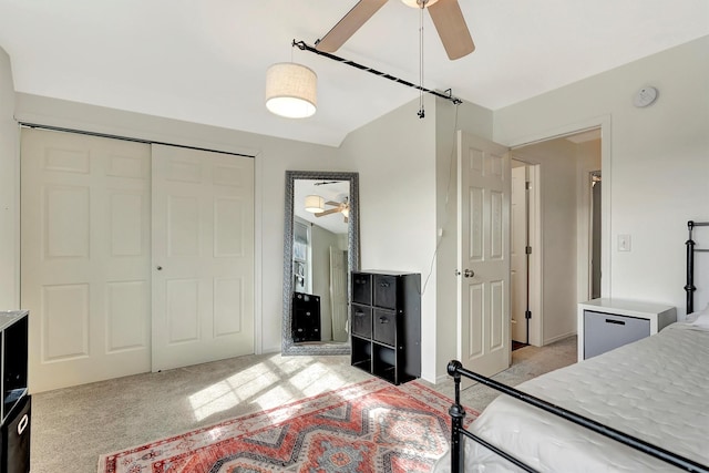 bedroom with light carpet, a closet, and a ceiling fan