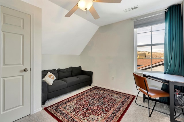 office space featuring baseboards, lofted ceiling, a ceiling fan, and visible vents