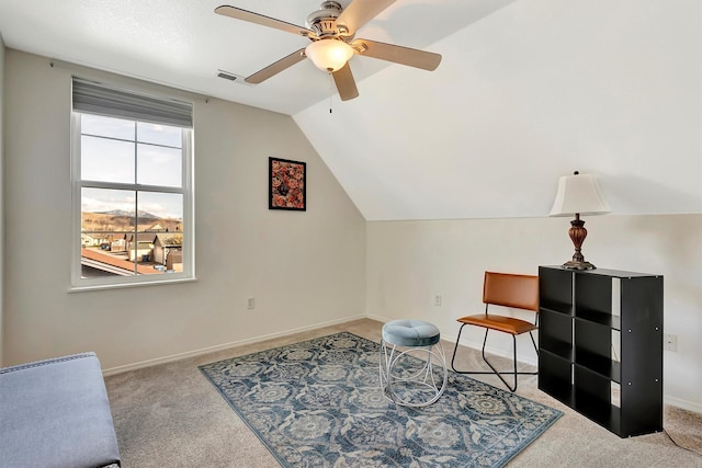 sitting room featuring a ceiling fan, visible vents, carpet flooring, lofted ceiling, and baseboards