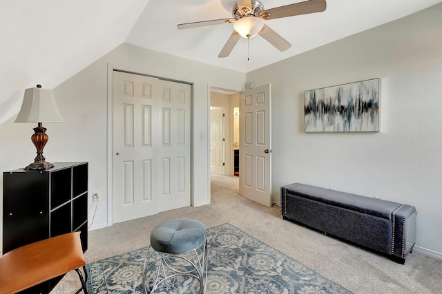 living area with ceiling fan and carpet