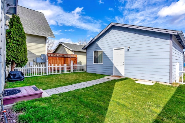 rear view of property with a yard and fence