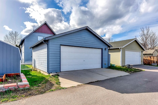 detached garage featuring fence