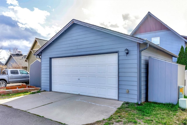 garage featuring concrete driveway