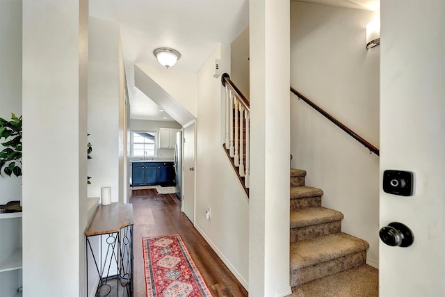 stairway featuring wood finished floors