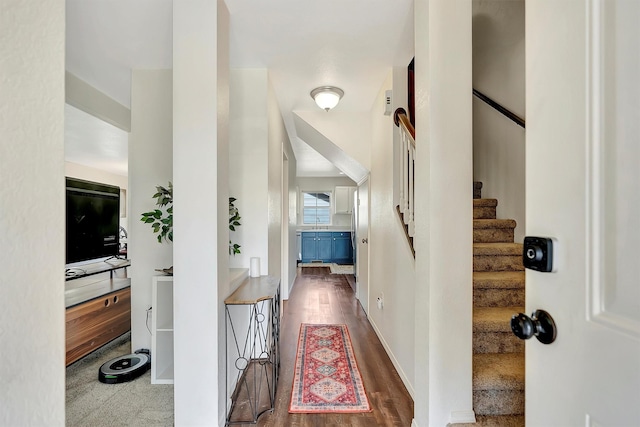 corridor with stairway and wood finished floors