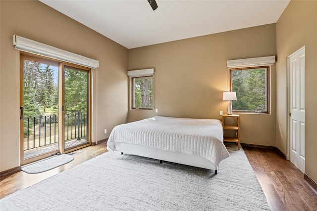 1636 Lake Blaine Rd, Kalispell, MT 59901 - bedroom featuring access to exterior, wood finished floors, baseboards, and a ceiling fan