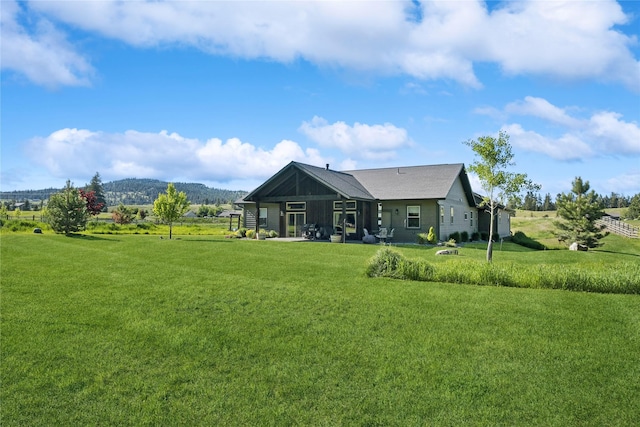 124 Hidden Waters Ln, Kalispell, MT 59901 - rear view of house featuring a yard and a mountain view