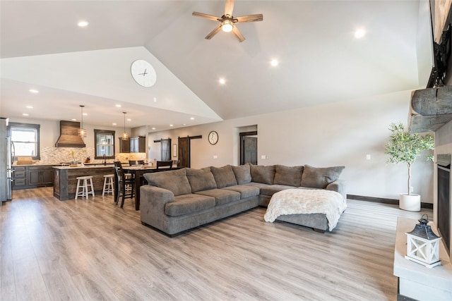 124 Hidden Waters Ln, Kalispell, MT 59901 - living area with high vaulted ceiling, light wood finished floors, ceiling fan, and recessed lighting