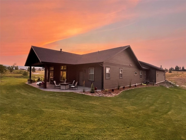 124 Hidden Waters Ln, Kalispell, MT 59901 - rear view of property featuring a patio area and a lawn