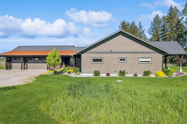 124 Hidden Waters Ln, Kalispell, MT 59901 - ranch-style home with gravel driveway, a front yard, and a garage