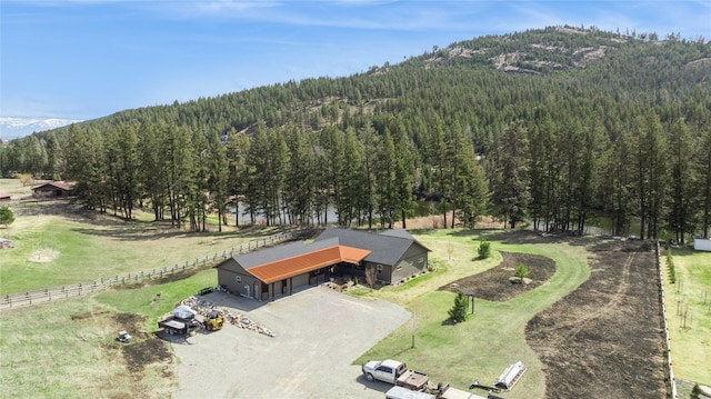 124 Hidden Waters Ln, Kalispell, MT 59901 - overview of rural landscape featuring a mountain backdrop and a heavily wooded area